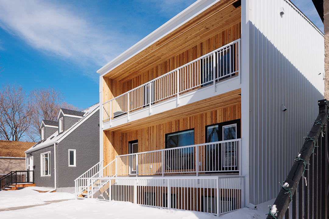 Rear exterior with cedar-clad balconies and white railings